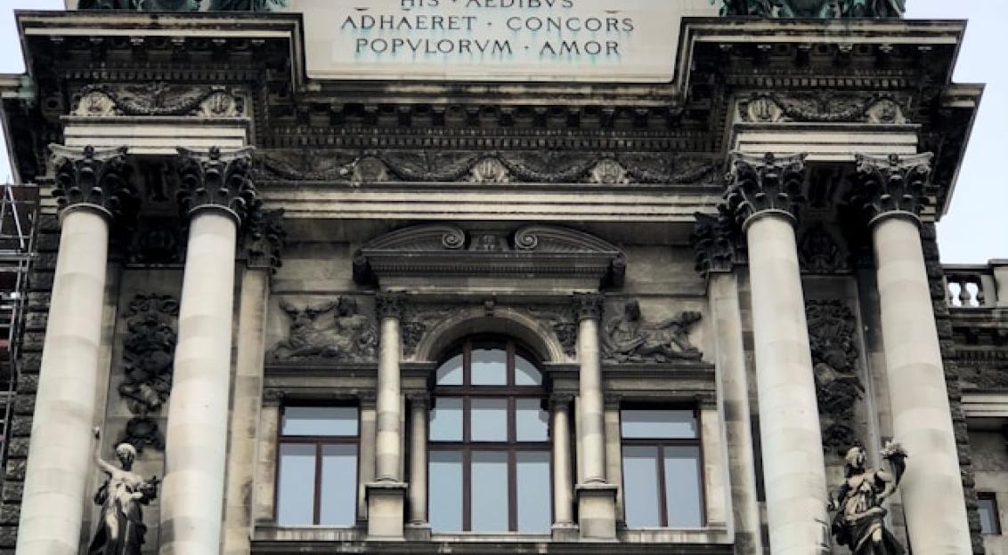 An illustrative photo of a concrete building during daytime 