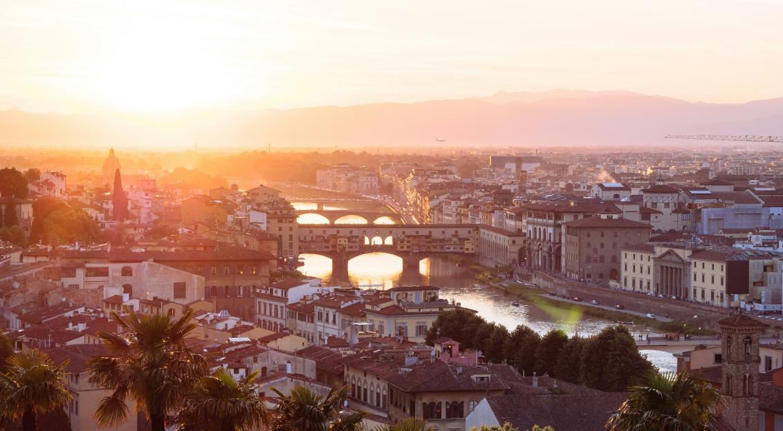 Photo by Unsplash An illustrative photo of the city’s historic architecture and the Arno River under a warm sunset in Florence, Italy