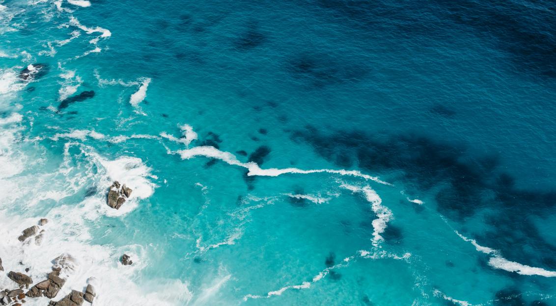 An illustrative photo of aerial view of seashore with stones
