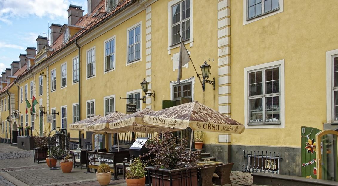 Photo by Pixabay An illustrative photo of the cafe terrace near the yellow concrete building in Latvia