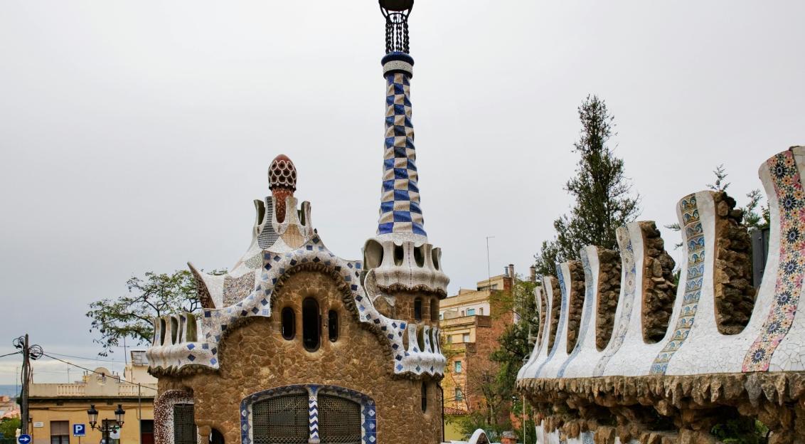 An illustrative photo of a whimsical building with mosaic details and undulating shapes
