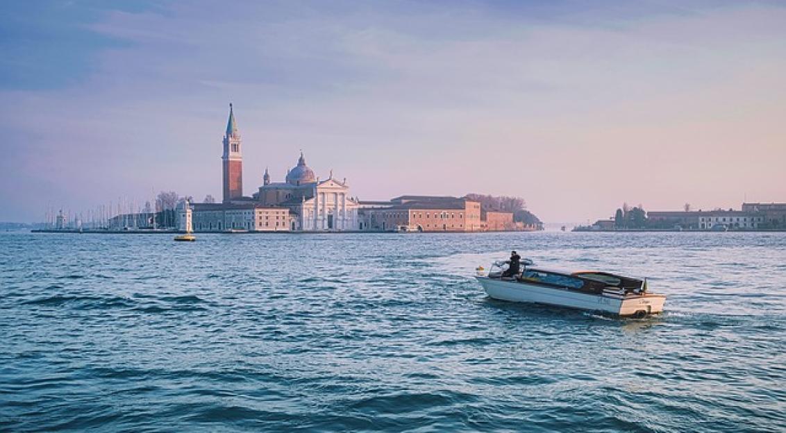 An illustrative photo of a canal in Venice, Italy