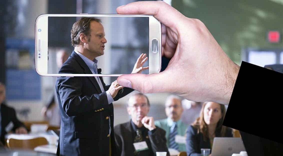 An illustrative photo of a video recording a conference