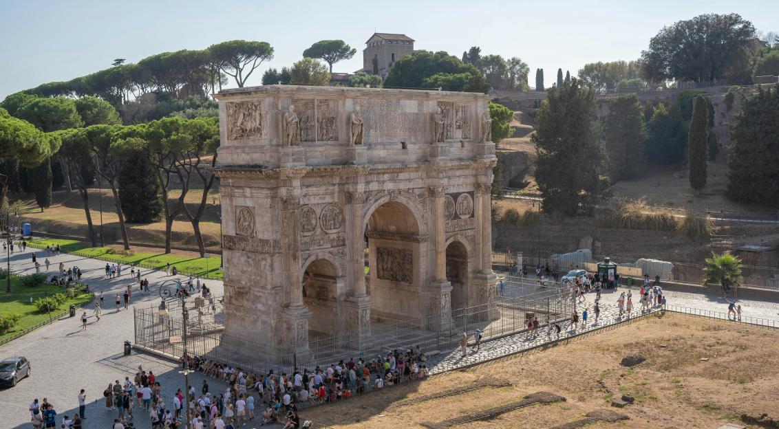 Photo by Unsplash An illustrative photo of a group of people walking around an ancient building.