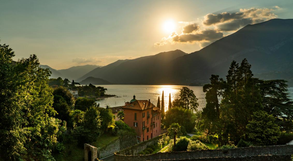An illustrative photo of the sun setting over a village.