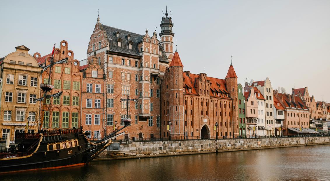 An illustrative photo of old European city district on river coast