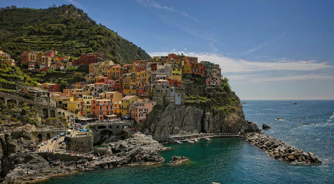 Photo by Unsplash An illustrative photo of houses on a hill near a body of water.