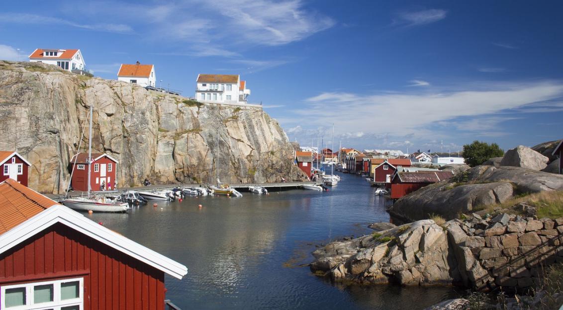 An illustrative photo of houses on the cliffs near a body of water in Sweden