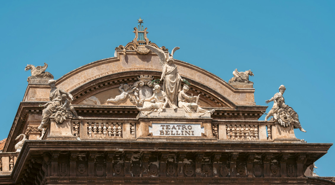 An illustrative photo of a large building with statues on top of it