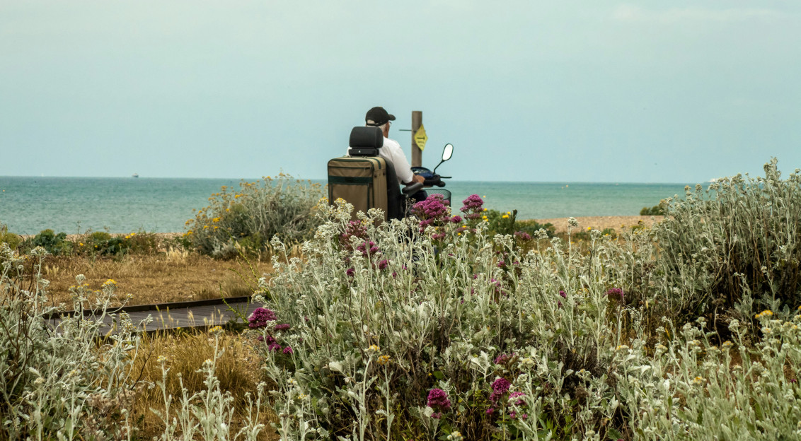 Photo by Unsplash An illustrative photo of a man in a wheelchair on the seashore