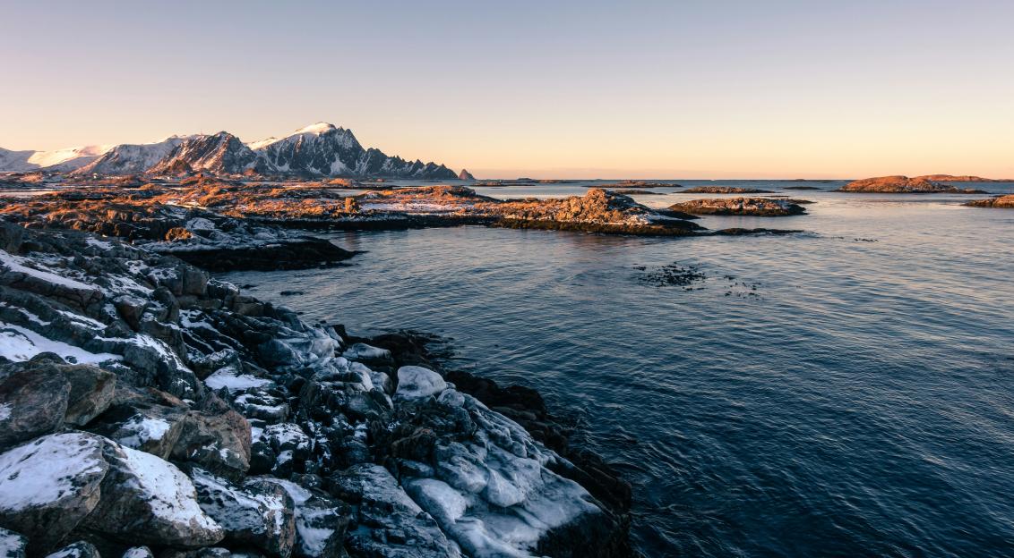 An illustrative photo of snow-covered coast near a body of water