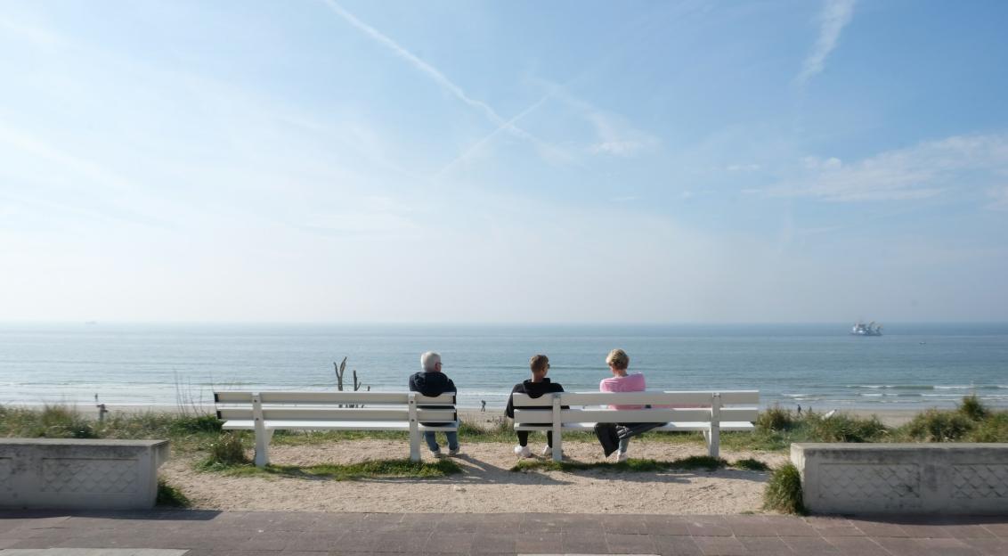 An illustrative photo of a couple of people sitting on a bench.
