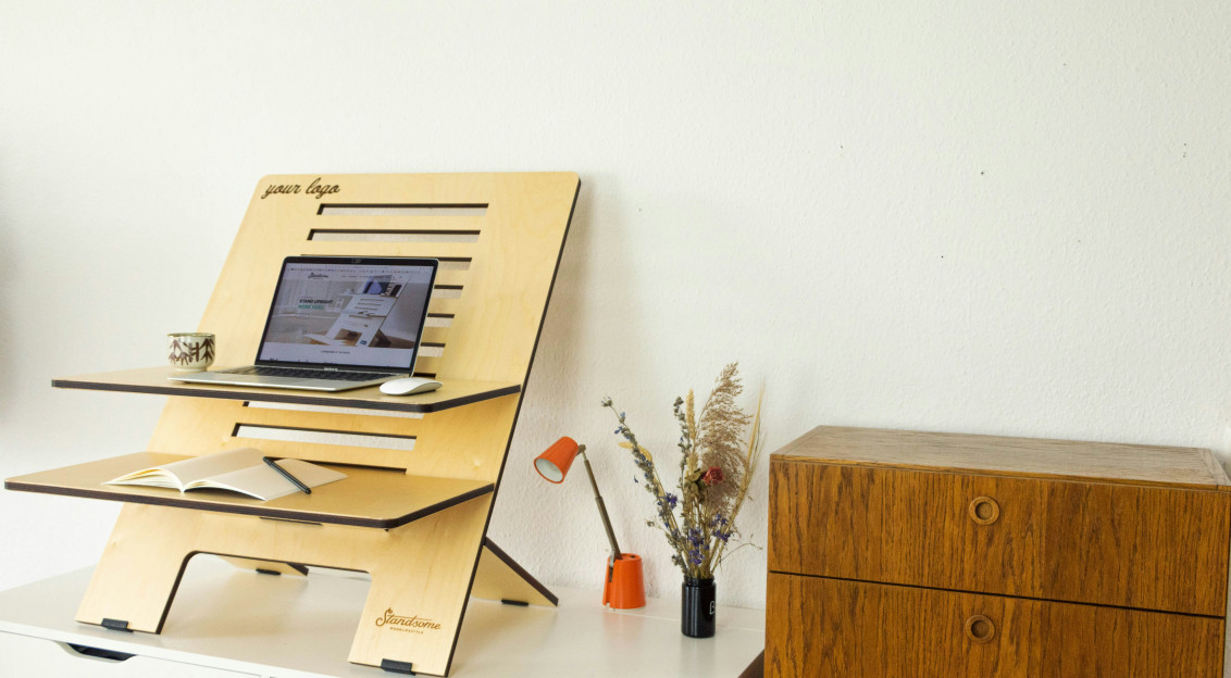 An illustrative photo of a desk with a computer on top of it