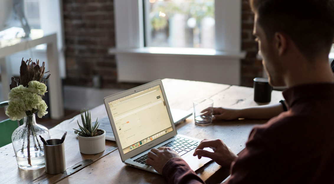 Photo by Unsplash An illustrative photo of a man operating laptop on top of table