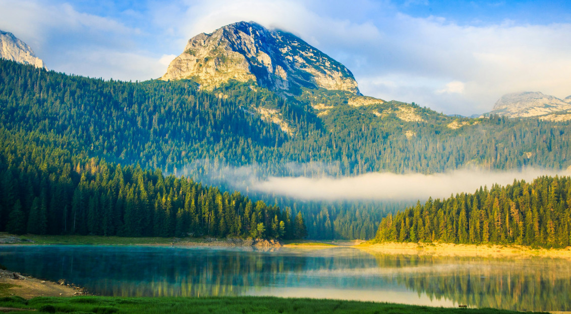 An illustrative photo of a lake near a mountain.