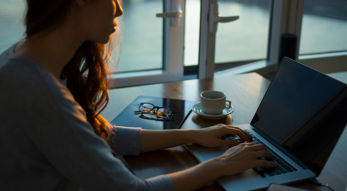 Photo by Unsplash An illustrative photo of a woman sitting beside table using laptop