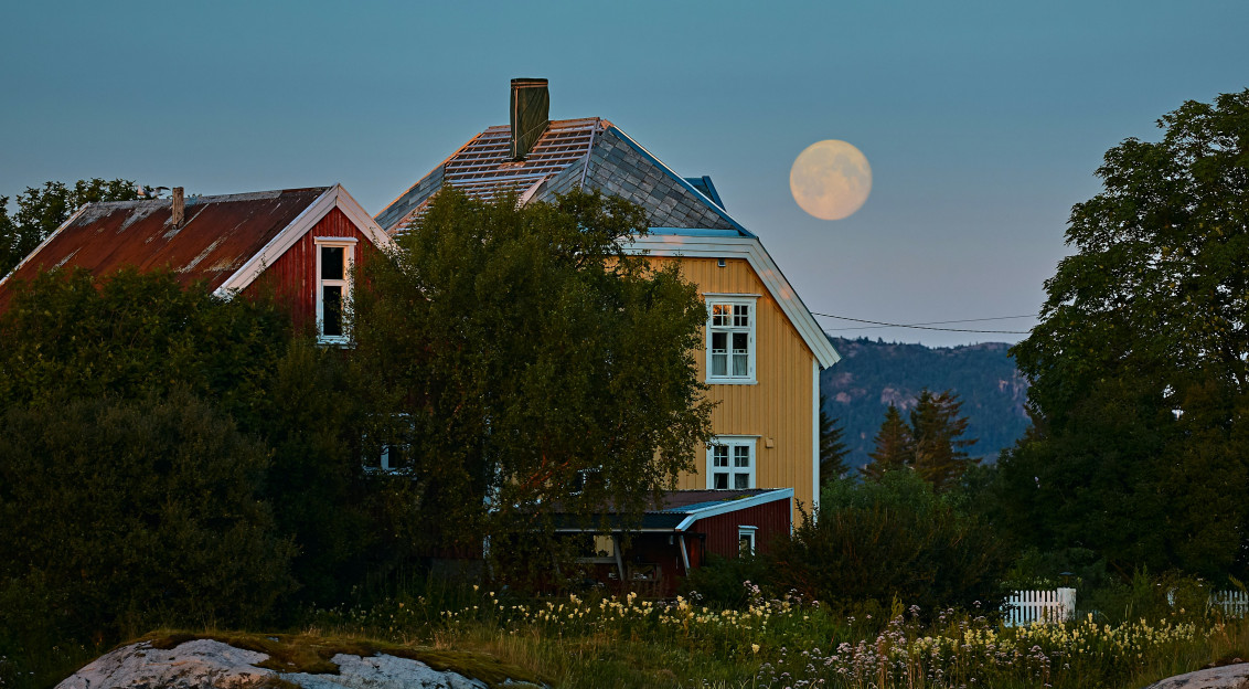 An illustrative photo of yellow and red painted barns
