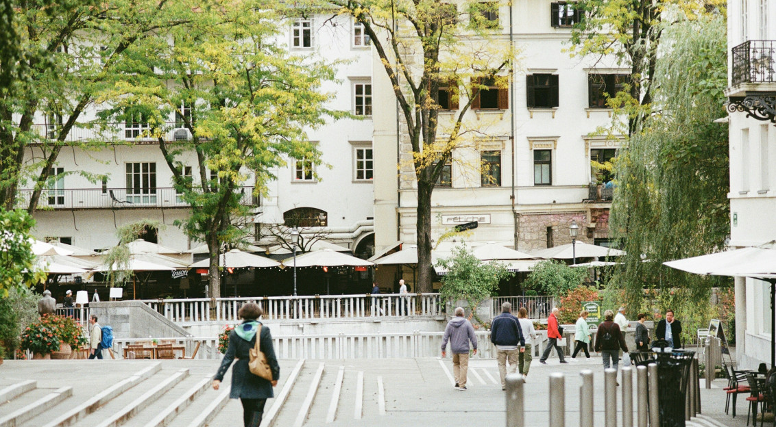 Photo by Unsplash An illustrative photo of people walking on sidewalk in the central district of Ljubljana