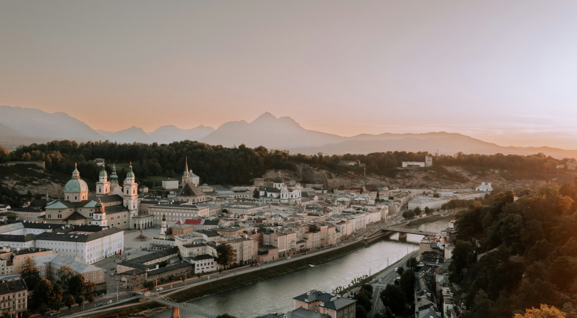 An illustrative photo of a city with a river running through it.