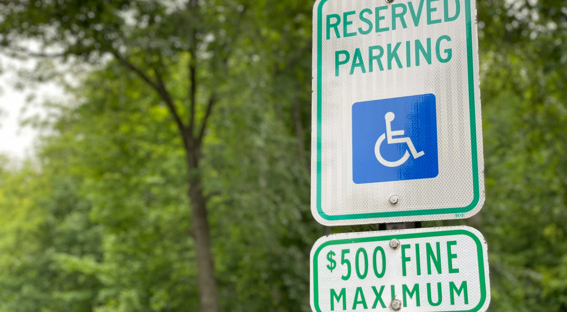 An illustrative photo of a sign with a symbol of parking for disabled