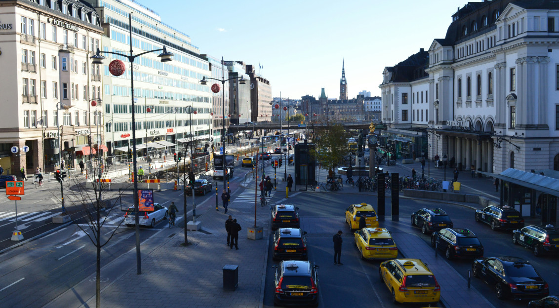 An illustrative photo of a city street filled with lots of traffic next to tall buildings.