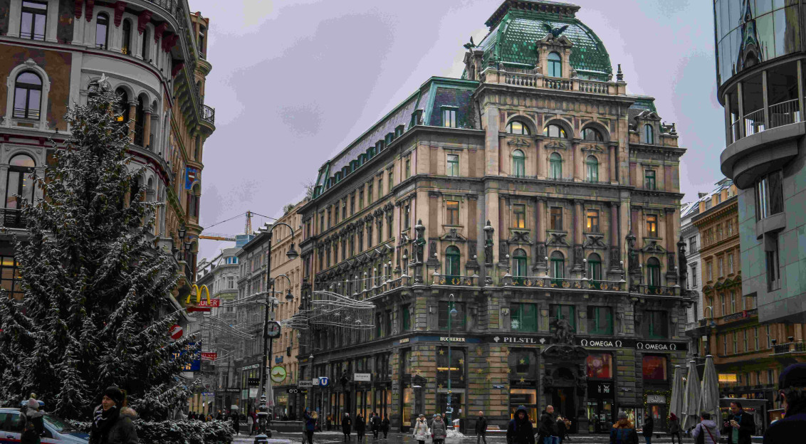 An illustrative photo of people walking on a central street in Vienna during winter.