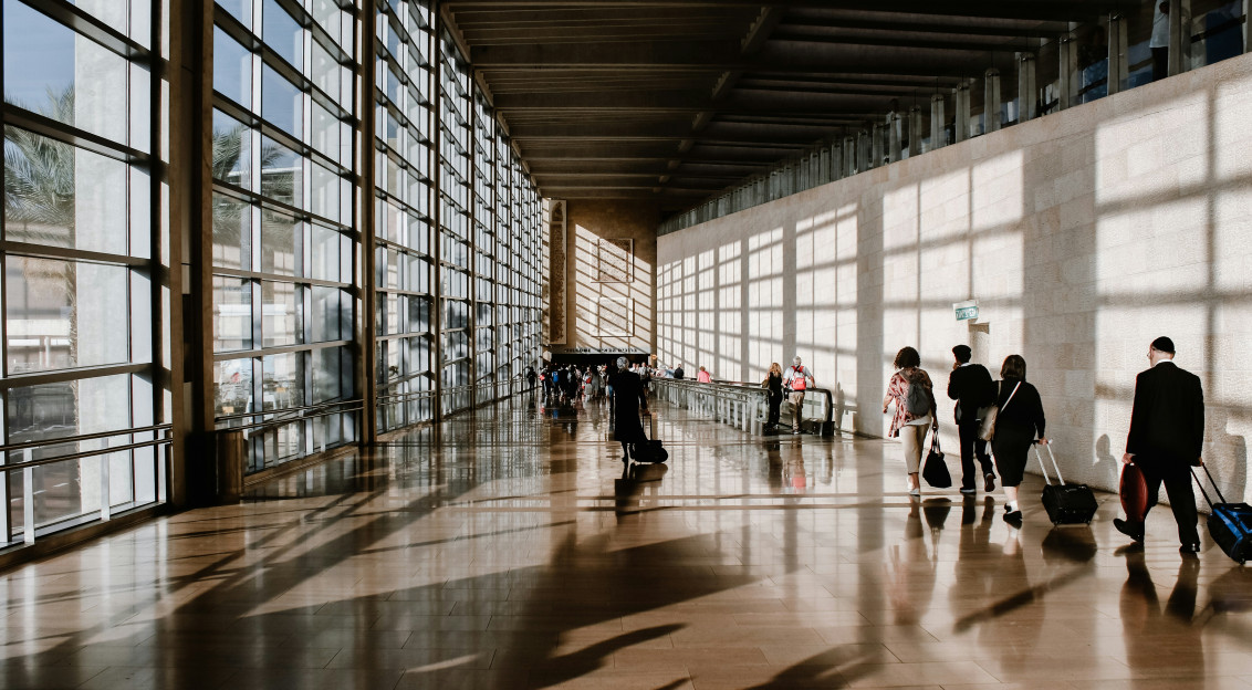 Photo by Unsplash An illustrative photo of people with suitcases walking in the airport