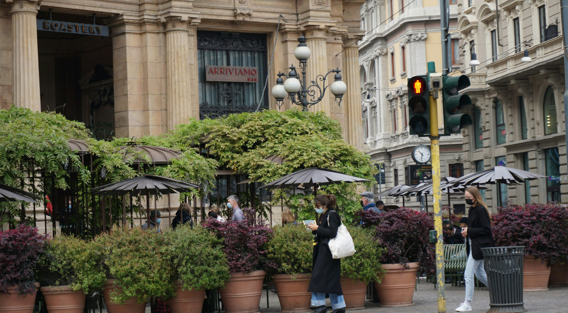 An illustrative photo of a woman walking on sidewalk.