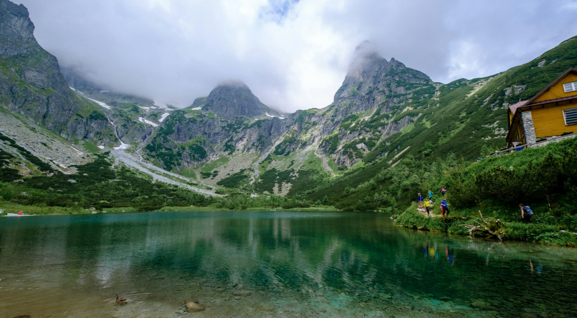 Photo by Unsplash An illustrative photo of green mountains beside lake.