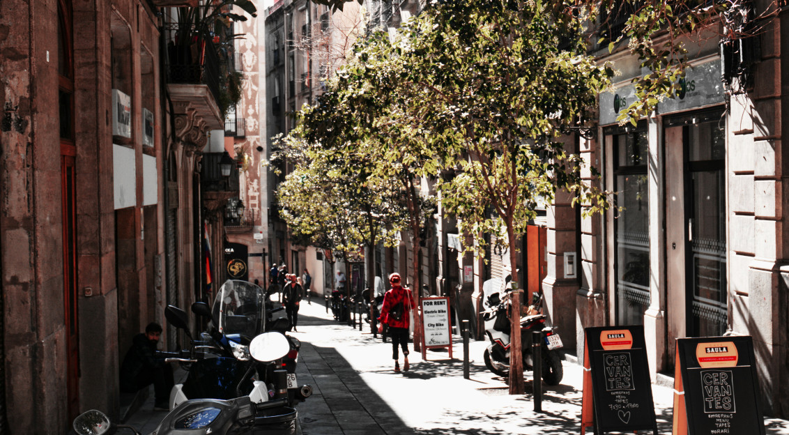 An illustrative photo of a person walking on an empty narrow street.