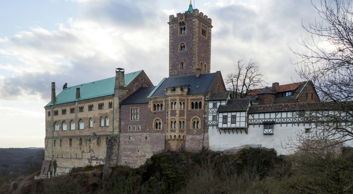 Image by Unsplash An illustrative photo of a white and brown castle under white clouds.