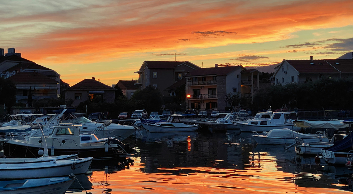 Image by Unsplash An illustrative photo of boats on a dock during sunset.