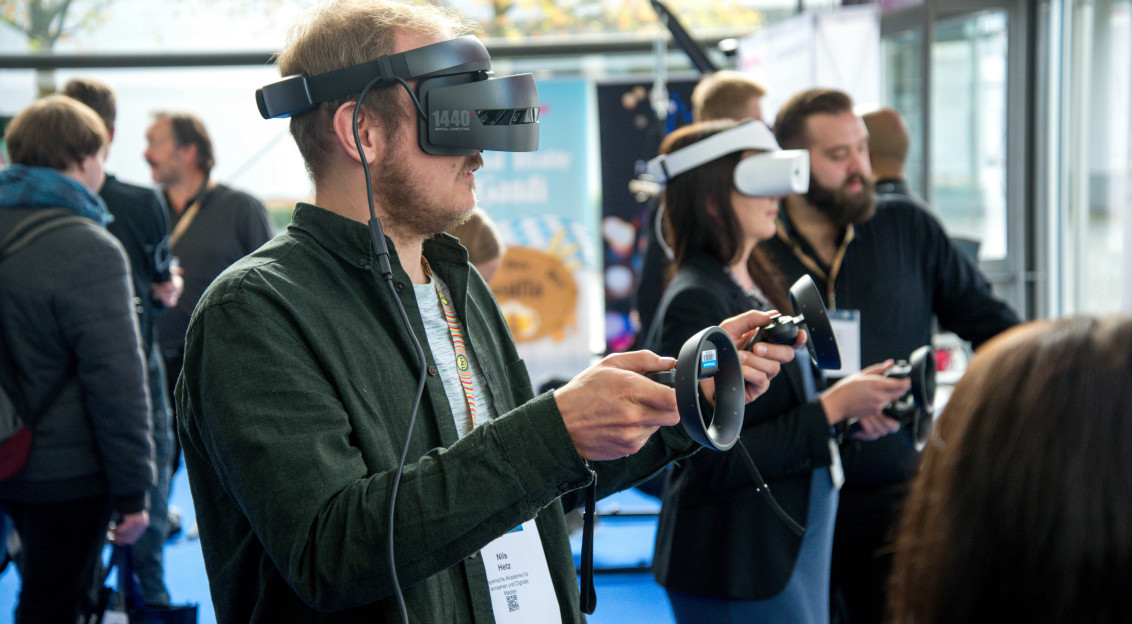 An illustrative photo of a person wearing VR smartphone headset.