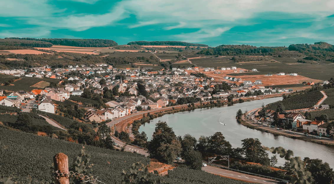An illustrative photo of a town on a hill near a river.