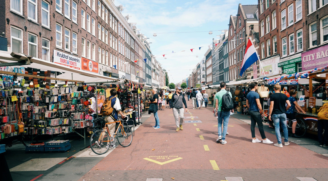 Image by Unsplash An illustrative photo of people walking on pedestrian lane on a street fair.
