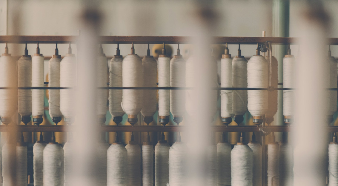 Photography of white treadle on brown wooden rack.