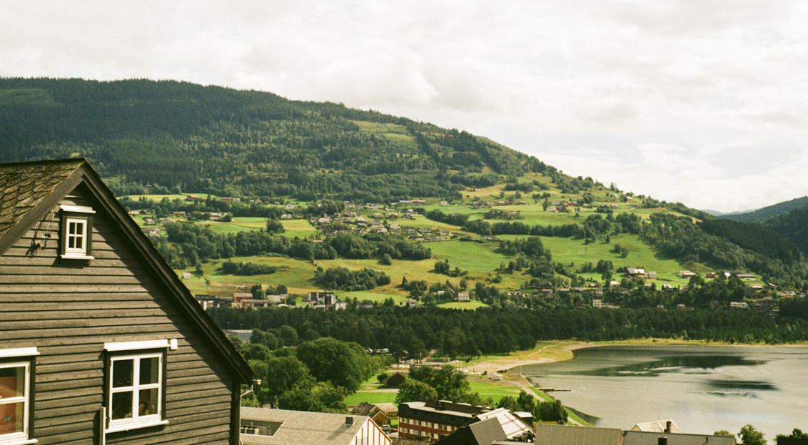 Photo by Unsplash An illustrative photo of a view of a village and a lake from a hill.