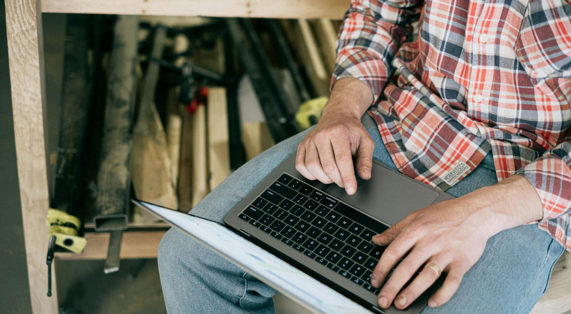 Person in Blue Denim Jeans Using Macbook Pro · Free Stock Photo