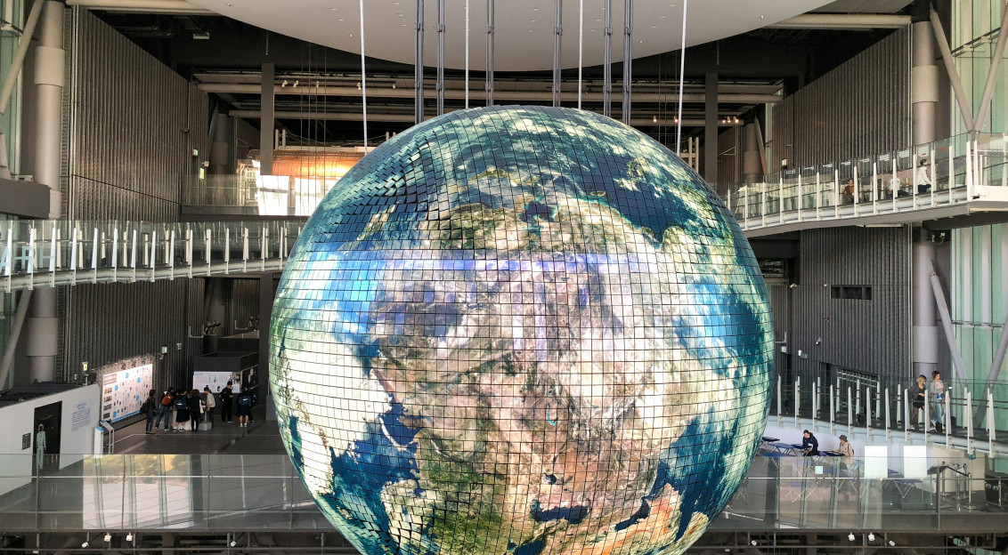 An illustrative photo of a giant globe inside of a building.