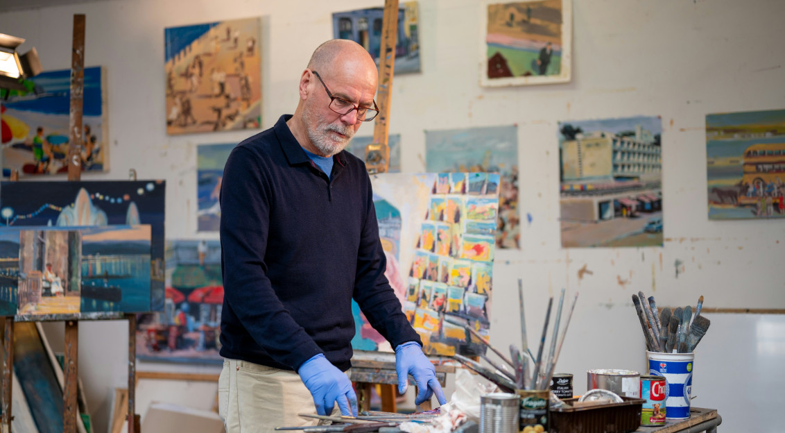 Photo by Unsplash An illustrative photo of a man in a blue shirt painting.