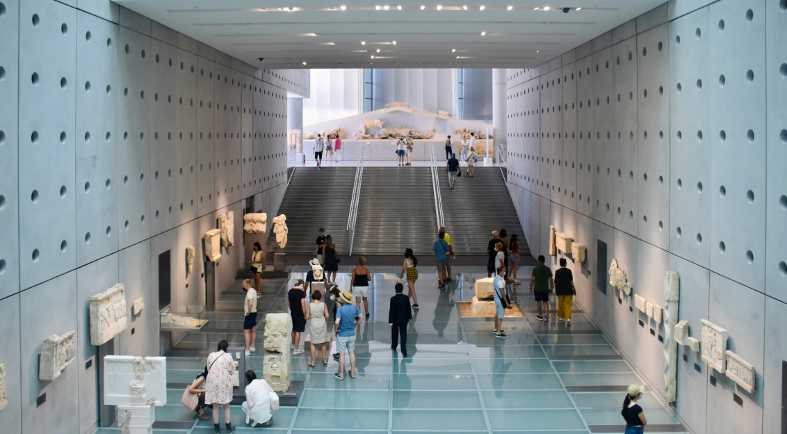 Photo by Unsplash An illustrative photo of people walking in a white modern museum.