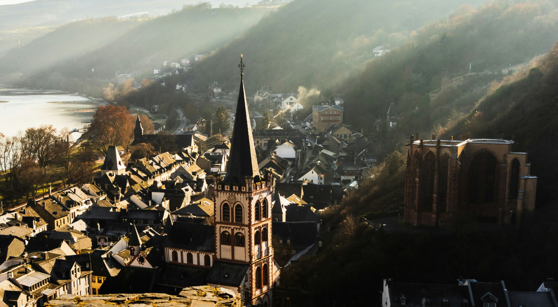 Photo by Unsplash An illustrative photo of a town between mountains and a lake.