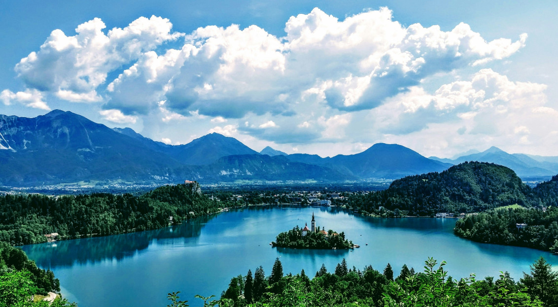 Photo by Unsplash An illustrative photo of an island in the middle of a lake surrounded with mountains.