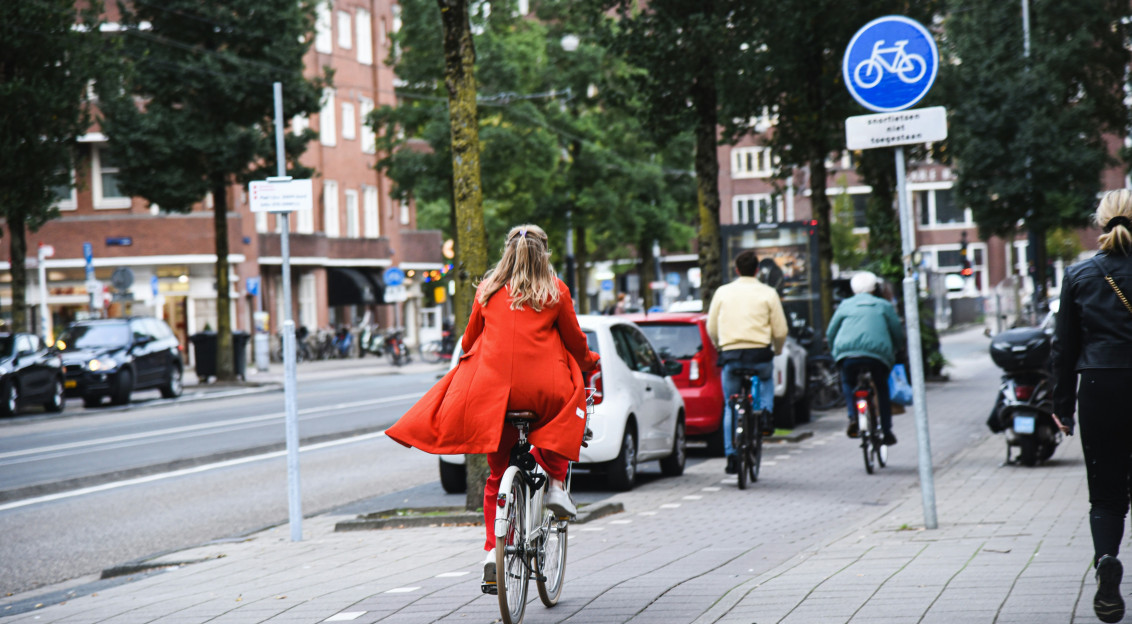 Photo by Unsplash An illustrative photo of people riding bicycles on the street.