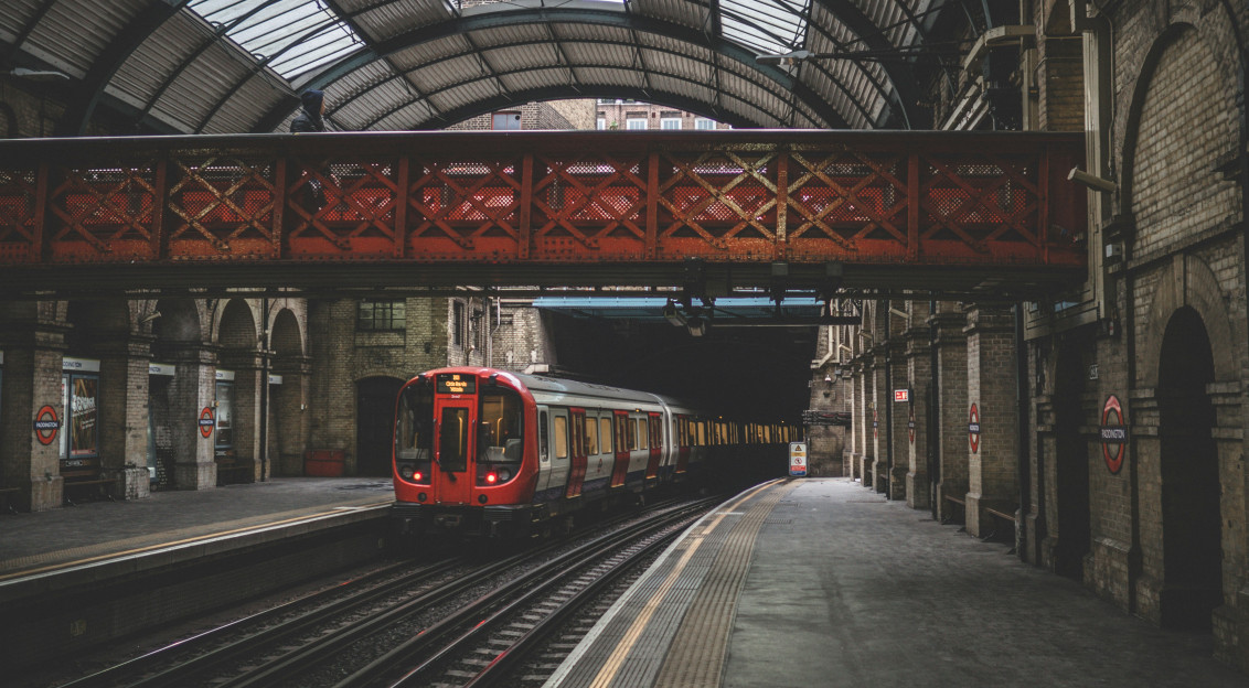 Photo by Unsplash An illustrative photo of a red train traveling inside a train station.