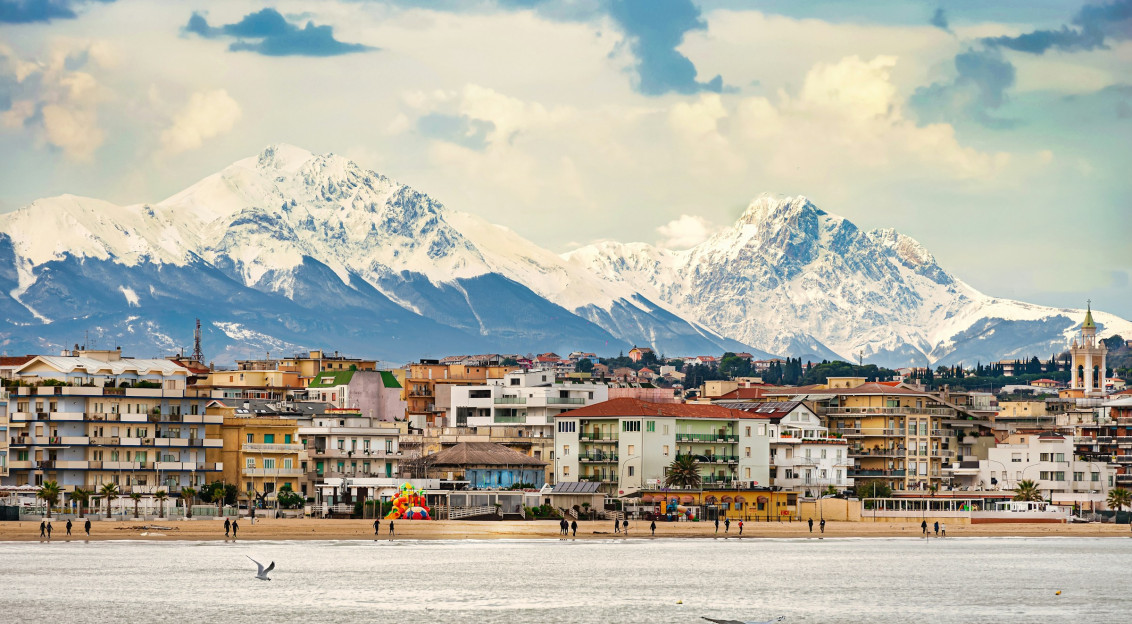 An illustrative photo of a view of a city with mountains.