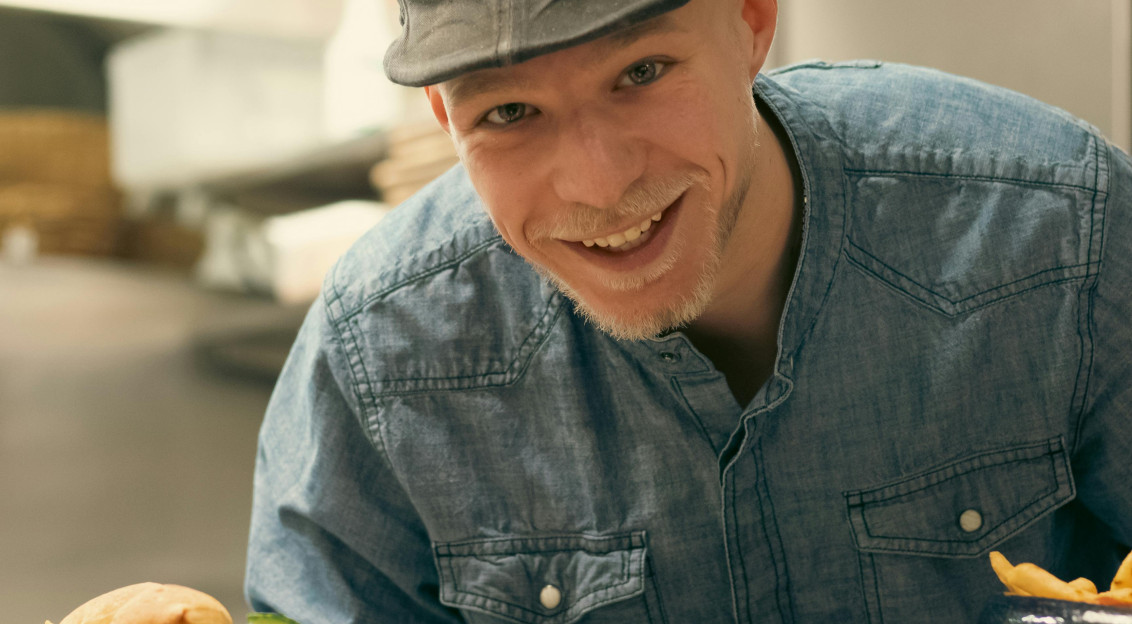 An illustrative photo of a man delivering food.