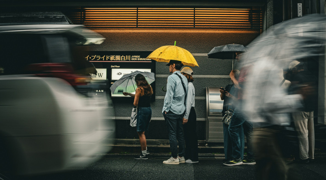 Photo by Unsplash An illustrative photo of people stand under umbrellas.
