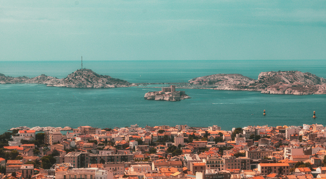 Photo by Unsplash An illustrative photo of city buildings near a sea.