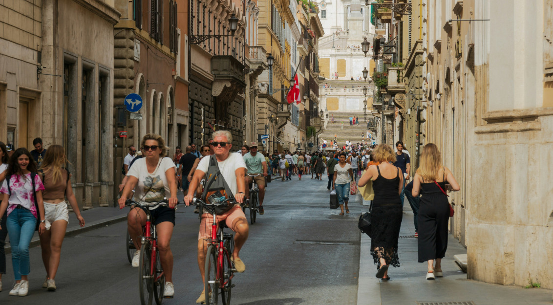 An illustrative photo of people riding bicycles in a city.